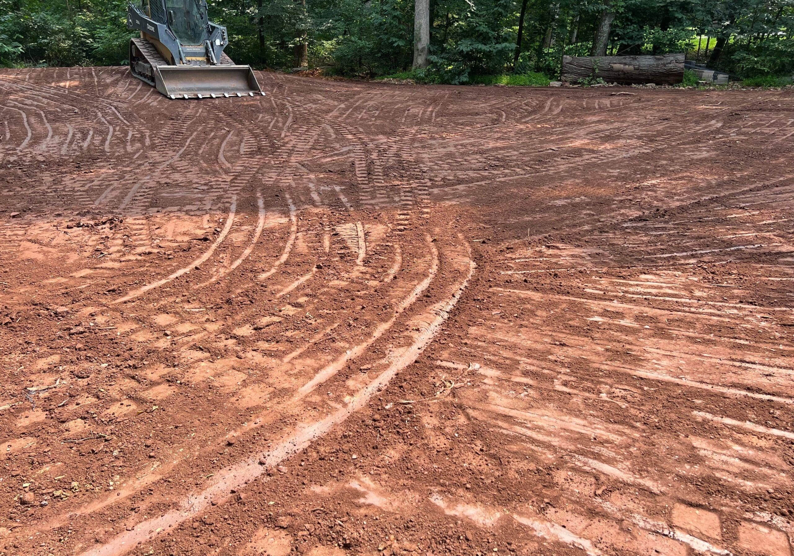 Freshly graded backyard area prepared for landscaping or lawn installation